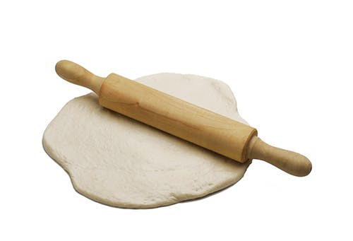 use a rolling pin to roll out dough into free form circles. each pizza crust should be about 1/2 inch thick.